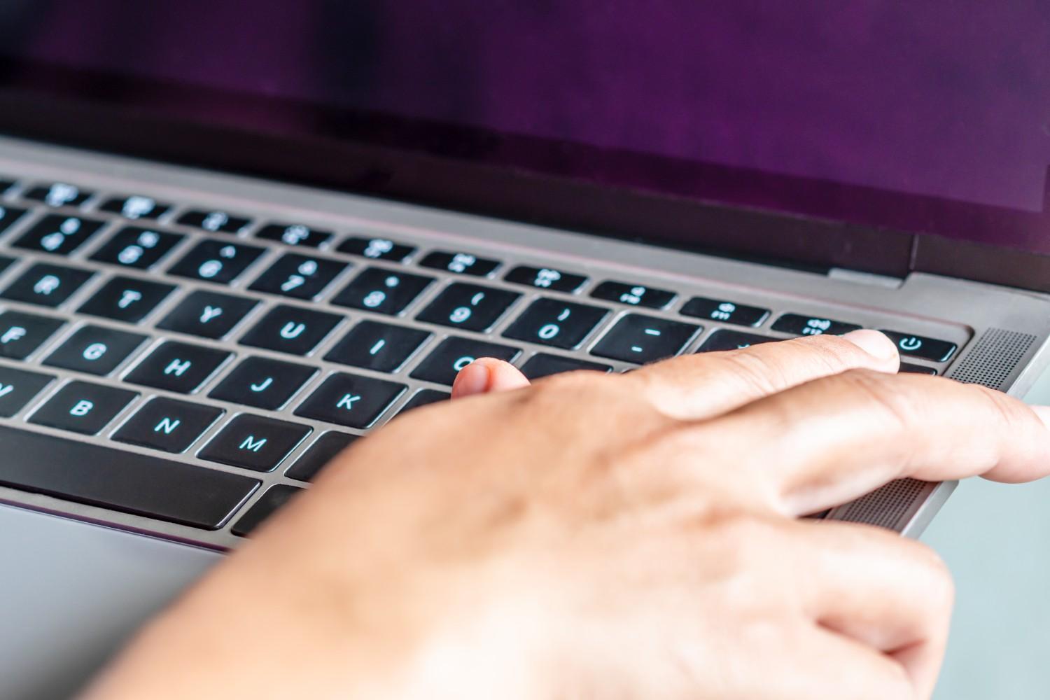 after-clicking-saving-all-business-work-use-your-finger-press-button-turn-it-off-closed-gray-laptop-computer-placed-it-table-is-time-finish-each-day-before-going-home-closeup (1).jpg